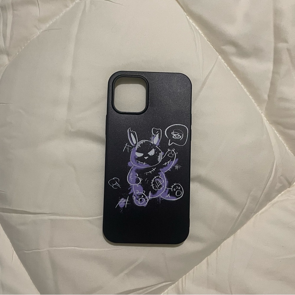 Black phone case with purl and white mean teddy graphic.